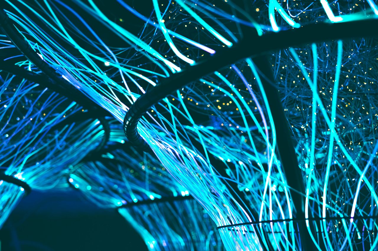 Mastering the First Impression: Your intriguing post title goes here A mesmerizing display of glowing neon blue optical fibers creating a futuristic atmosphere.